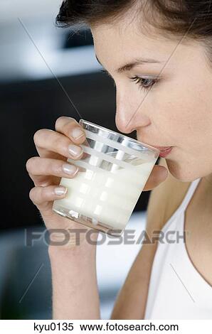 Portrait of a young woman drinking milk View Large Photo Image Stock Photography - Portrait of a young woman drinking milk. Fotosearch