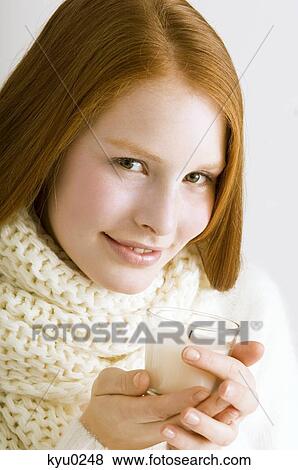 Portrait of a young woman holding a burning candle and smiling View Large Photo Image Stock Photo - Portrait of a young woman holding a burning candle and smiling. Fotosearch
