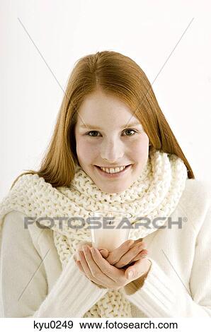 Portrait of a young woman holding a burning candle and smiling View Large Photo Image Stock Photo - Portrait of a young woman holding a burning candle and smiling. Fotosearch