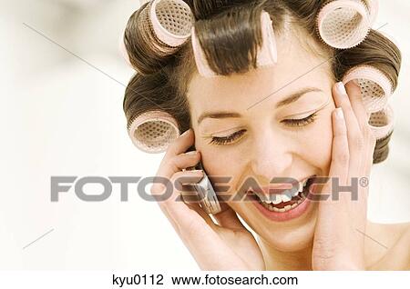 Portrait of a young woman in curlers phoning View Large Photo Image Stock Image - Portrait of a young woman in curlers phoning. Fotosearch