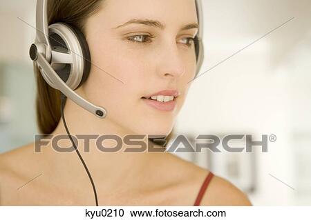 Portrait of a young woman, listening to music with headphones View Large Photo Image Stock Image - Portrait of a young woman, listening to music with headphones. Fotosearch