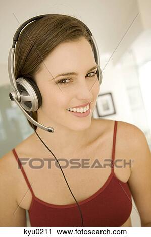 Portrait of a young woman, listening to music with headphones View Large Photo Image Stock Image - Portrait of a young woman, listening to music with headphones. Fotosearch