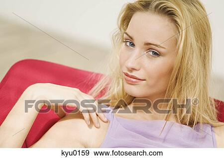 Portrait of a young woman looking at the camera, blond hair View Large Photo Image Stock Photo - Portrait of a young woman looking at the camera, blond hair. Fotosearch