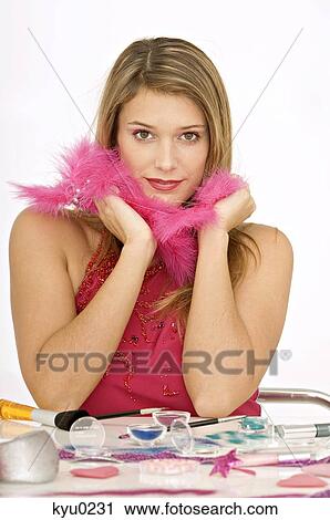 Portrait of a young woman with a feather boa around her neck View Large Photo Image Stock Image - Portrait of a young woman with a feather boa around her neck. Fotosearch
