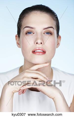 Portrait of young woman with hands on chin View Large Photo Image Stock Photo - Portrait of young woman with hands on chin. Fotosearch