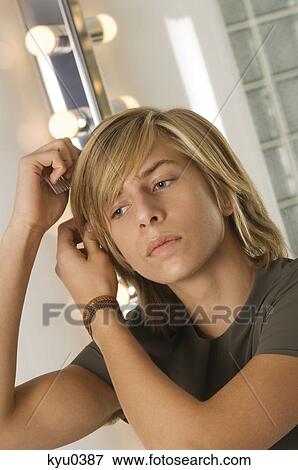 Stock Photo - Teenage boy combing his hair. Fotosearch