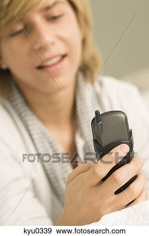 Teenage boy using a mobile phone View Large Photo Image Stock Photo - Teenage boy using a mobile phone. Fotosearch