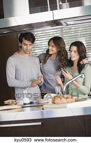 Three friends having breakfast in the kitchen View Large Photo Image Stock Image - Three friends having breakfast in the kitchen. Fotosearch