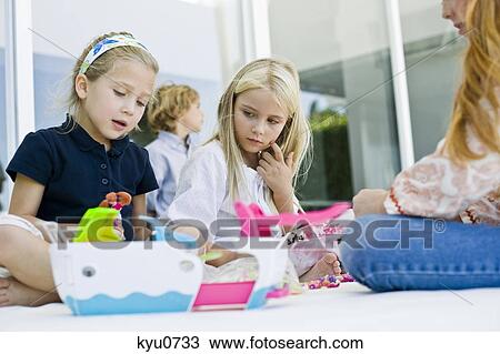 Three girls playing with toys View Large Photo Image Stock Image - Three girls playing with toys. Fotosearch