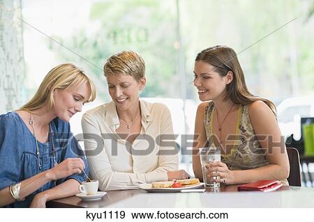 Three women sitting in a restaurant View Large Photo Image Stock Photo - Three women sitting in a restaurant. Fotosearch