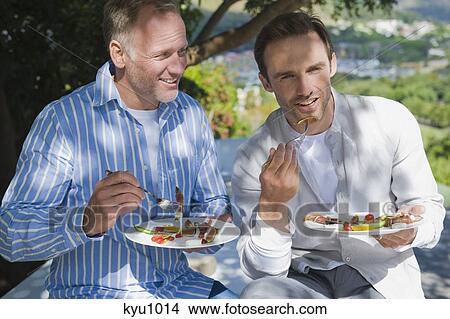 Two friends eating fruit salad View Large Photo Image Picture - Two friends eating fruit salad. Fotosearch