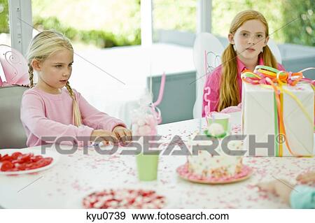 Two girls in a birthday party View Large Photo Image Stock Photo - Two girls in a birthday party. Fotosearch