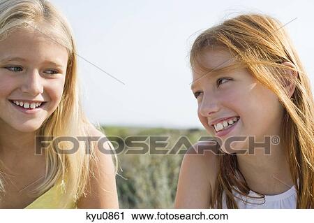 Two girls smiling View Large Photo Image Stock Image - Two girls smiling. Fotosearch