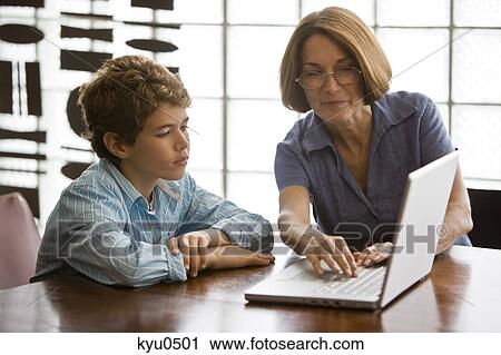 Woman and her grandson using a laptop View Large Photo Image Stock Image - Woman and her grandson using a laptop. Fotosearch