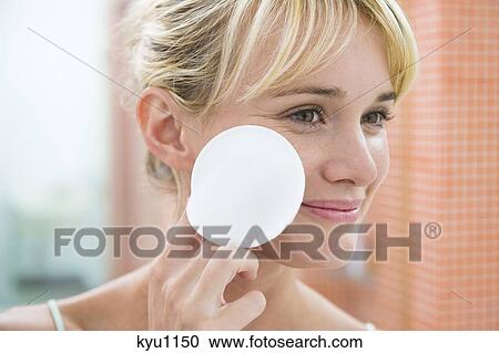 Stock Image - Woman applying face powder. Fotosearch