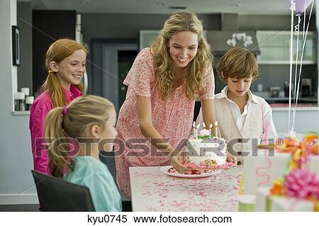 Woman celebrating her daughter's birthday View Large Photo Image Stock Photography - Woman celebrating her daughter's birthday. Fotosearch