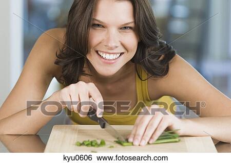 Stock Photograph - Woman chopping chives. Fotosearch