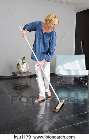 Woman cleaning floor with a mop View Large Photo Image Stock Photo - Woman cleaning floor with a mop. Fotosearch