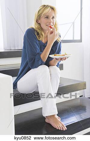 Woman eating fruit salad View Large Photo Image Stock Image - Woman eating fruit salad. Fotosearch