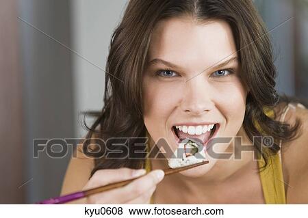Woman eating sushi View Large Photo Image Stock Photo - Woman eating sushi. Fotosearch