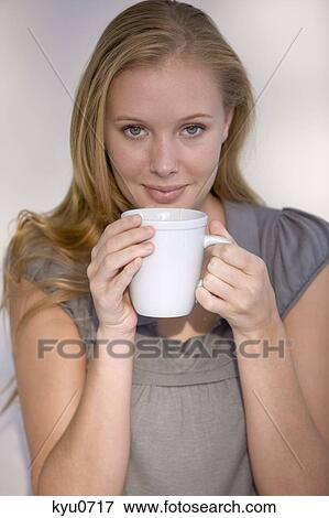 Woman holding a cup of coffee View Large Photo Image Stock Photo - Woman holding a cup of coffee. Fotosearch