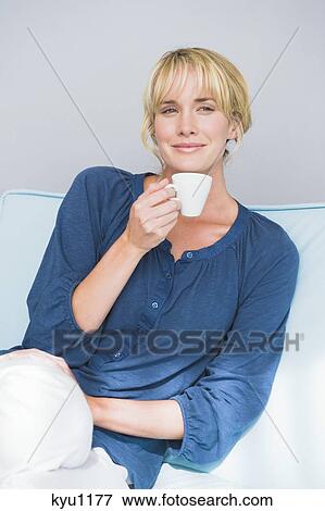 Woman holding a cup of tea View Large Photo Image Stock Photo - Woman holding a cup of tea. Fotosearch