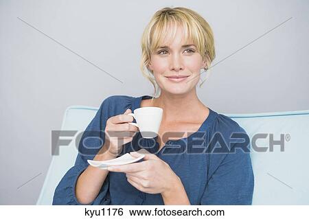 Stock Photograph - Woman holding a cup of tea. Fotosearch
