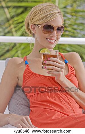 Woman holding a glass of cola View Large Photo Image Stock Photograph - Woman holding a glass of cola. Fotosearch