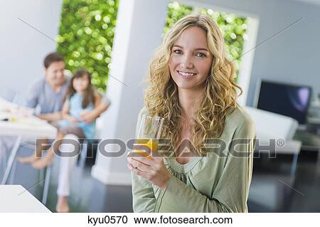 Stock Image - Woman holding a glass of juice. Fotosearch