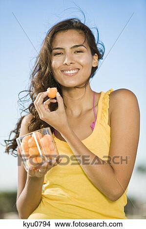 Woman holding a jar of fruits View Large Photo Image Picture - Woman holding a jar of fruits. Fotosearch