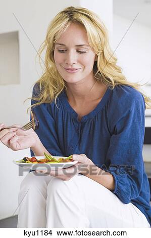 Woman holding a plate of fruit salad View Large Photo Image Picture - Woman holding a plate of fruit salad. Fotosearch