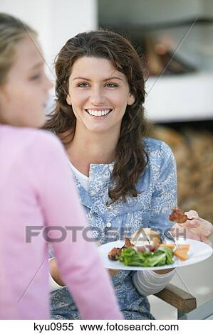 Woman holding a plate of kebab and smiling View Large Photo Image Stock Photography - Woman holding a plate of kebab and smiling. Fotosearch
