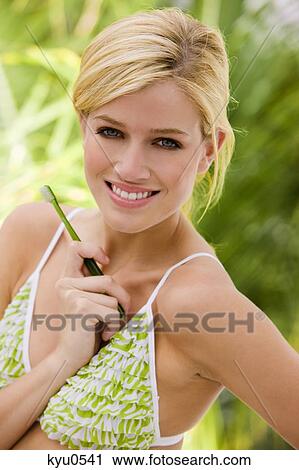 Stock Image - Woman holding a toothbrush. Fotosearch