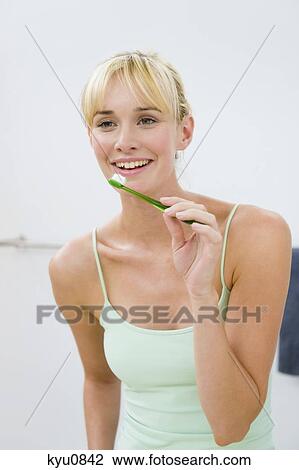 Woman holding a toothbrush View Large Photo Image Stock Image - Woman holding a toothbrush. Fotosearch