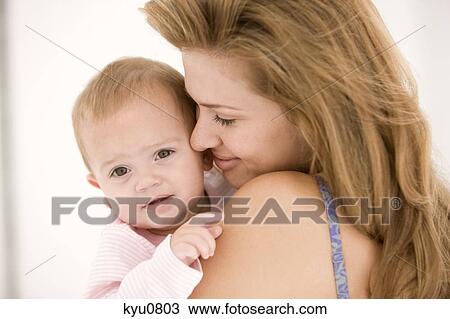 Woman holding her daughter View Large Photo Image Stock Image - Woman holding her daughter. Fotosearch