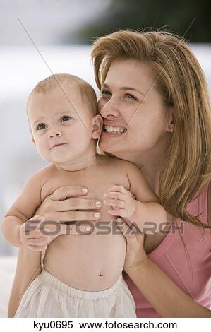 Woman holding her daughter View Large Photo Image Stock Photography - Woman holding her daughter. Fotosearch