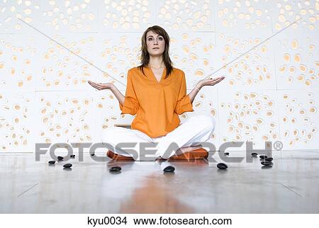 Woman in yoga position, sitting cross-legged View Large Photo Image Picture - Woman in yoga position, sitting cross-legged. Fotosearch