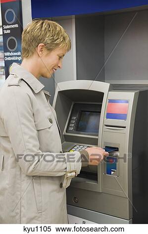 Woman inserting a credit card into ATM View Large Photo Image Stock Photography - Woman inserting a credit card into ATM. Fotosearch