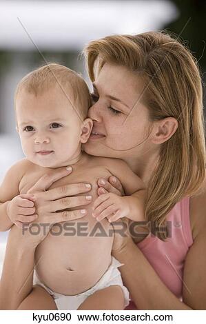 Woman kissing her daughter View Large Photo Image Stock Image - Woman kissing her daughter. Fotosearch