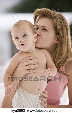 Woman kissing her daughter View Large Photo Image Stock Image - Woman kissing her daughter. Fotosearch