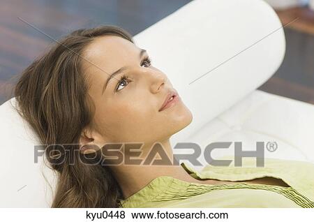 Woman lying on the bed View Large Photo Image Stock Photo - Woman lying on the bed. Fotosearch