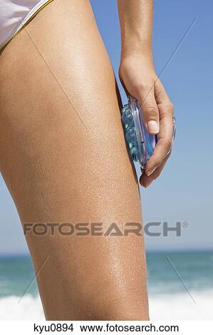 Woman massaging her leg with a massager View Large Photo Image Picture - Woman massaging her leg with a massager. Fotosearch
