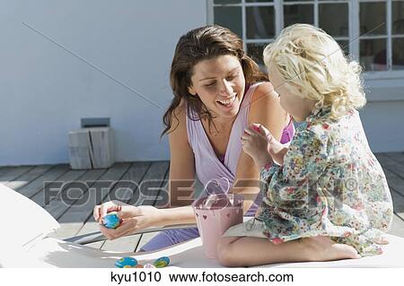 Woman playing with her daughter View Large Photo Image Stock Image - Woman playing with her daughter. Fotosearch