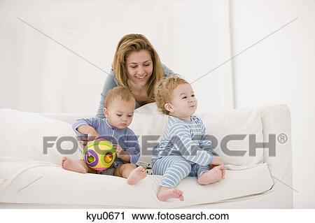 Woman playing with her son and daughter on a couch View Large Photo Image Stock Image - Woman playing with her son and daughter on a couch. Fotosearch