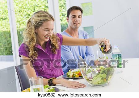 Woman pouring salad oil in salad and smiling View Large Photo Image Stock Image - Woman pouring salad oil in salad and smiling. Fotosearch