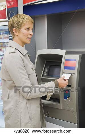 Woman receiving a transaction slip from an ATM View Large Photo Image Stock Image - Woman receiving a transaction slip from an ATM. Fotosearch