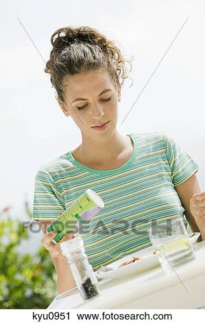 Woman seasoning salad View Large Photo Image Stock Image - Woman seasoning salad. Fotosearch