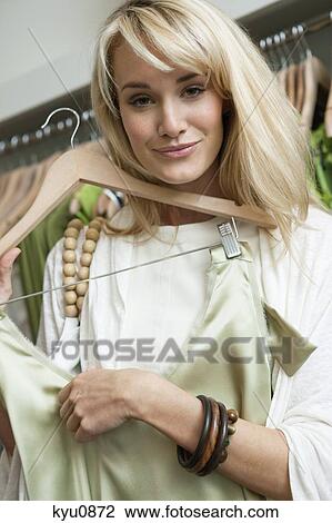 Stock Image - Woman shopping in a boutique. Fotosearch