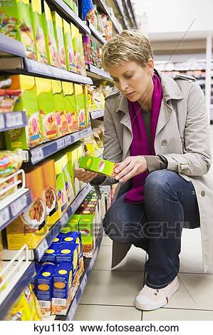 Stock Image - Woman shopping in a supermarket. Fotosearch