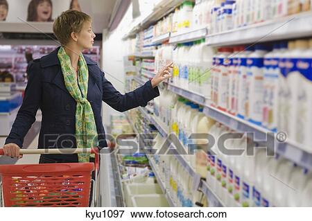 Woman shopping in a supermarket View Large Photo Image Stock Photo - Woman shopping in a supermarket. Fotosearch